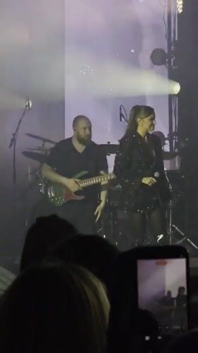Female singer performs with band in Linz, Austria