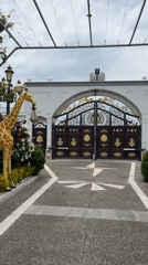 Decorative animal statues displayed near ornate gate with foliage