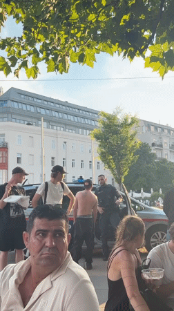 Vienna plaza buzzes with fountain play, football screens, and street life