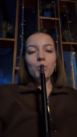 Woman enjoys hookah session at dimly lit Klin lounge