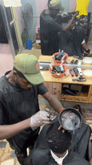 Evening barbershop operations documented in Nkpor, Nigeria