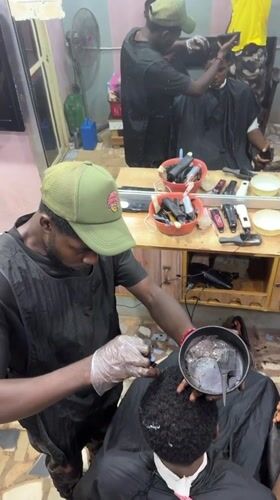 Evening barbershop operations documented in Nkpor, Nigeria