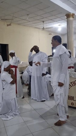 Religious ceremony in white robes held in Lagos hall