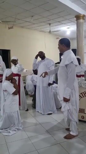 Religious ceremony in white robes held in Lagos hall