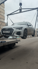 Dusty Audi A3 towed by crane in Krasnoyarsk