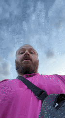 Man in pink shirt photographed on rural road in Russia