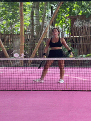 Women play racket sport on pink court in General Luna