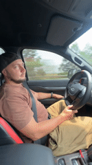 Man in Ford vehicle crosses arms in Vietnam