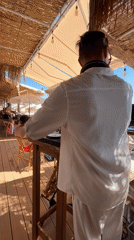 DJ and sax duo perform at a Sutomore beach club