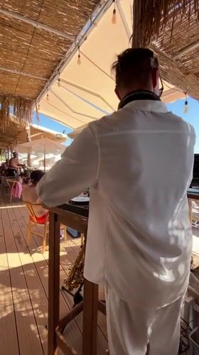 DJ and sax duo perform at a Sutomore beach club