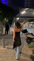 Woman walks toward Tel Aviv playground late night
