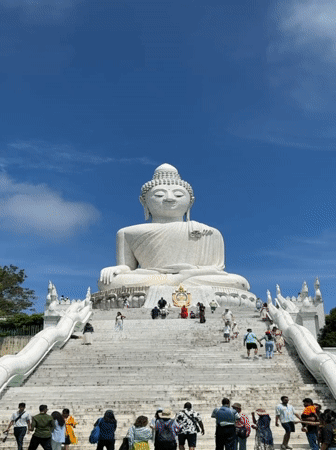 Tourists document Big Buddha landmark in Karon, Thailand
