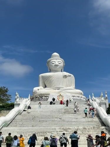 Tourists document Big Buddha landmark in Karon, Thailand