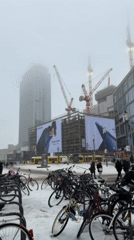 Woman documents snowy day at Berlin shopping center