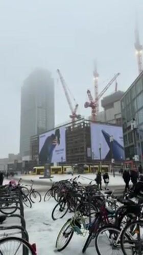 Woman documents snowy day at Berlin shopping center