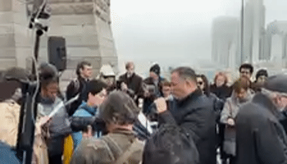 Religious gathering with cross observed on Brooklyn Bridge walkway