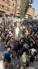 Vehicle wreckage draws crowds in Gaza amid emergency response