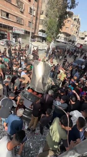 Vehicle wreckage draws crowds in Gaza amid emergency response