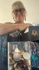 Woman organizes coffee pods into storage container in Chambœuf