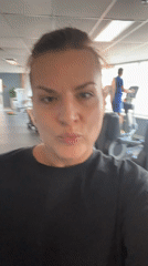 Woman smiles at camera in Novosibirsk gym