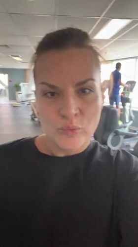Woman smiles at camera in Novosibirsk gym