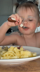 Child enjoys meal with face paint in Reshetnikovo