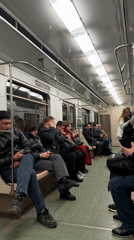 Moscow metro passengers ride underground train during afternoon commute
