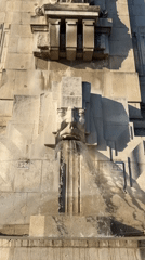 Milan Centrale: stone fountain, grand facade, military vehicle outside