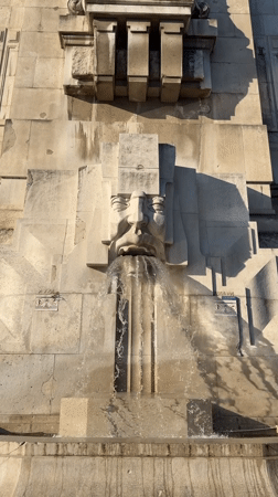 Milan Centrale: stone fountain, grand facade, military vehicle outside