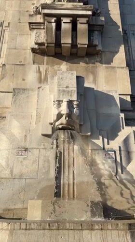 Milan Centrale: stone fountain, grand facade, military vehicle outside