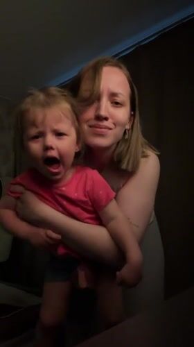 Woman takes selfies, dances with child in Reshetnikovo home