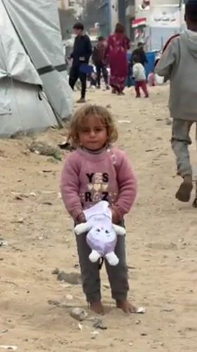 Child with toy observed in Gaza refugee camp