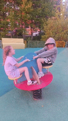 Spring afternoon captures playground, sunset, and blossoming trees