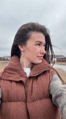 Woman, child visit Kama Reservoir waterfront on overcast day