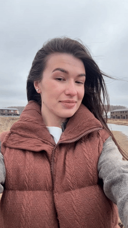 Woman, child visit Kama Reservoir waterfront on overcast day