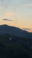 Flare burns against mountain backdrop near Cetinje, Montenegro
