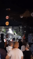 Live music night in Bandung with crowds, bands, and cultural staging