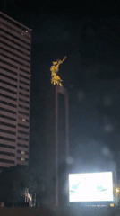 Night monuments illuminated amid Jakarta cityscape