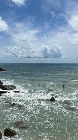 Beachgoers swim at Baan Chaweng Noi during early morning hours