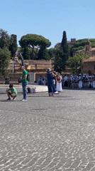 Violinist performs near St. Peter's Basilica on a clear Rome morning