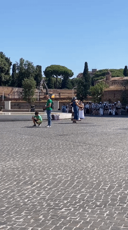 Violinist performs near St. Peter's Basilica on a clear Rome morning