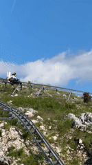 Tourist rides mountain coaster in Montenegro hills
