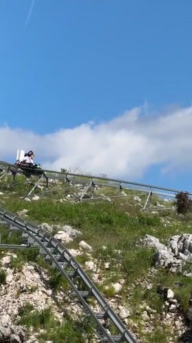 Tourist rides mountain coaster in Montenegro hills