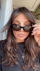 Woman removes sunglasses in Tel Aviv
