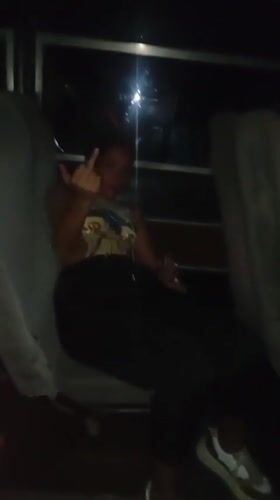 Woman poses, gestures for camera on late-night bus in Venezuela