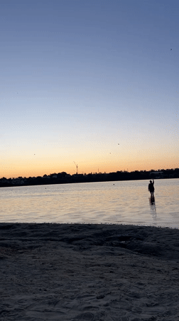 Running toward the water at golden hour on a Ukrainian beach