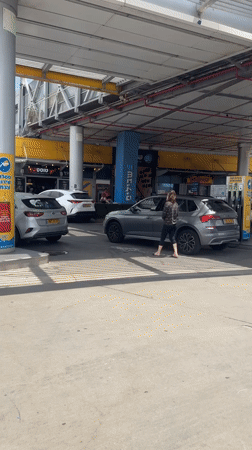 Woman refuels SUV at Kfar Vitkin gas station