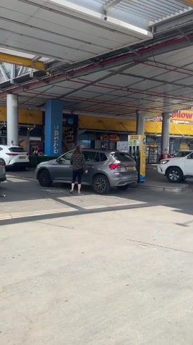 Woman refuels SUV at Kfar Vitkin gas station