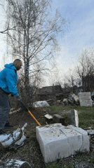 Man splits wood with axe in Noviy, Russia