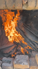 Wood fire burns in brick structure in Perushtitsa, Bulgaria